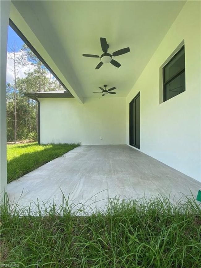 Trussed-in Tiled Spacious Lanai with Ceiling Fan | Image 17