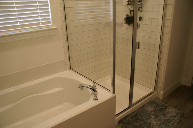 Bathroom featuring a tile shower stall, and separate tub | Image 21