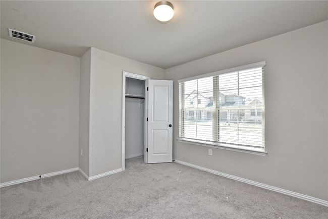 Unfurnished bedroom with visible vents, baseboards, a closet, and carpet flooring | Image 19