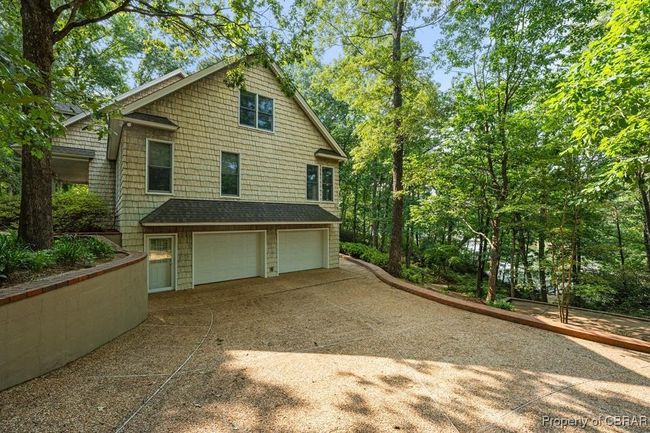 View of side of home featuring an attached garage and concrete driveway | Image 8