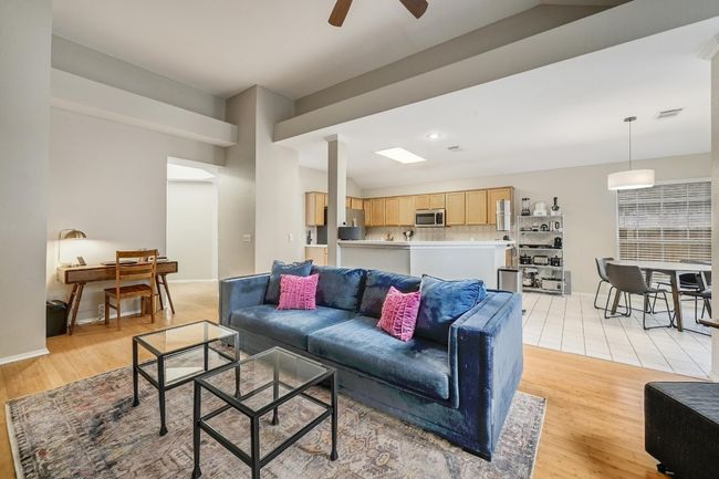Family room with a fireplace is open to the kitchen & breakfast area. | Image 10