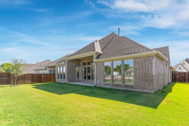 Back of house featuring brick siding, a shingled roof, and a patio | Image 37