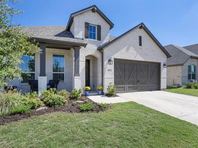 View of front facade featuring a front lawn and a garage | Image 2