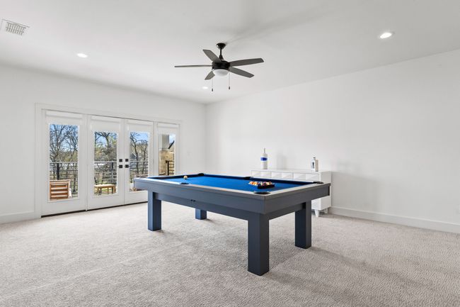 Playroom with carpet flooring, visible vents, ceiling fan, billiards, and french doors | Image 31