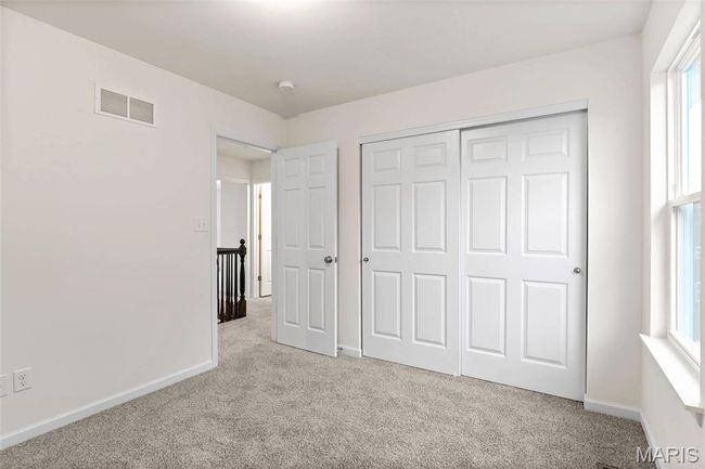 Unfurnished bedroom featuring light carpet, multiple windows, and a closet | Image 20