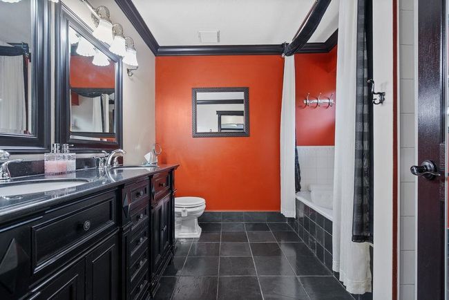 Bathroom featuring ornamental molding, toilet, tile patterned floors, and double vanity | Image 21