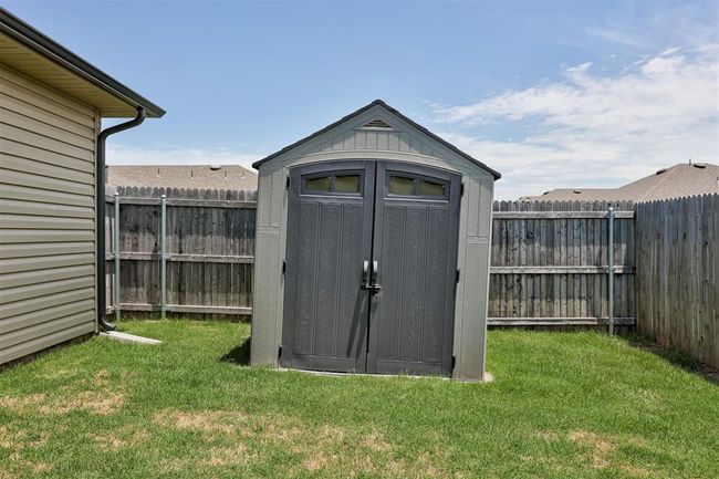 View of shed with a fenced backyard | Image 43