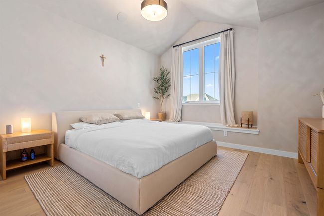 Bedroom featuring lofted ceiling, baseboards, and light wood-type flooring | Image 17