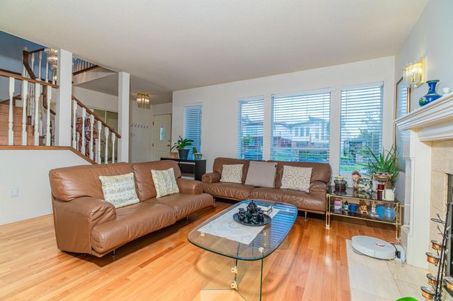 Living room featuring stairway and wood finished floors | Image 6