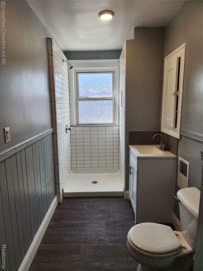 Bathroom with a stall shower, vanity, and dark wood finished floors | Image 7