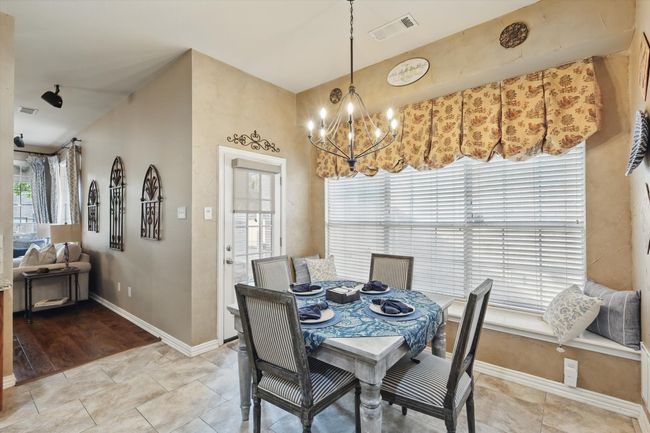 Dining space with a chandelier, baseboards, and light tile patterned flooring | Image 13