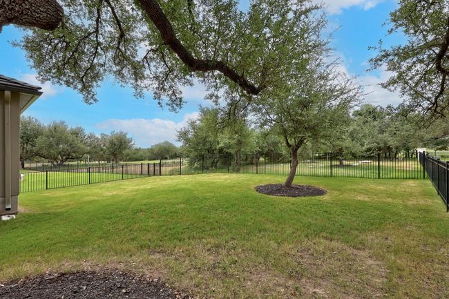 Fenced backyard featuring view of wooded area/golf course | Image 30