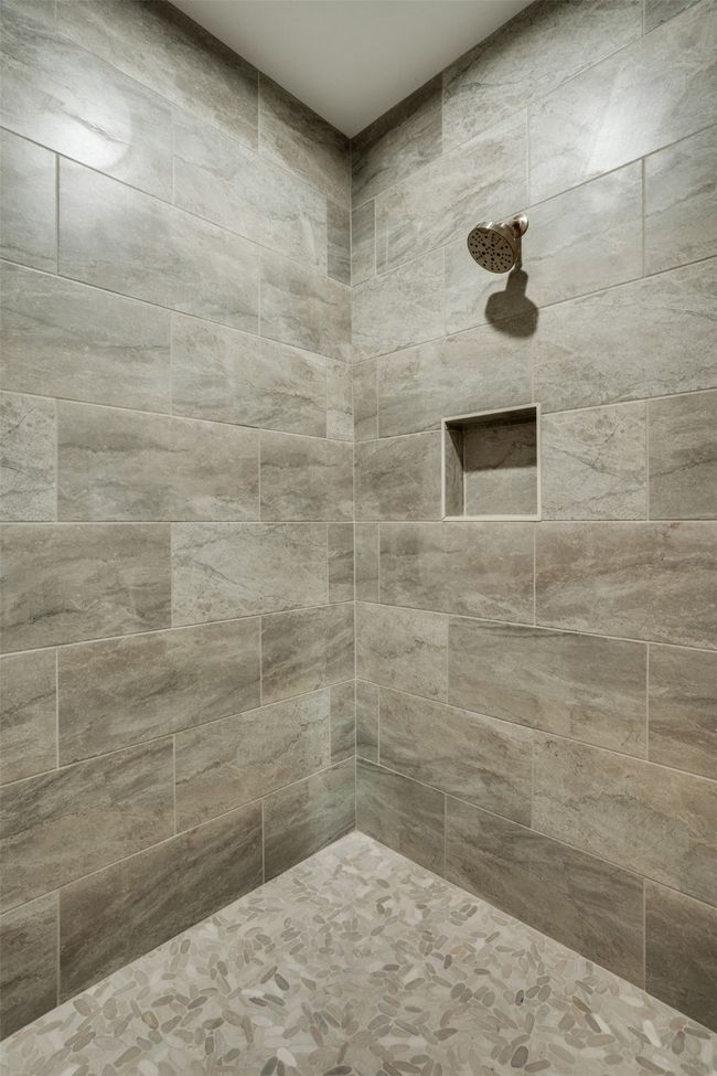 Bathroom featuring a tile shower | Image 16