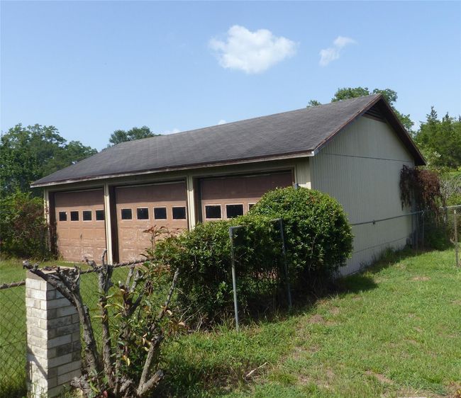 Spacious 3-car detached garage offering ample room for vehicles, storage, or a workshop—ideal for hobbyists, collectors, or extra space needs. | Image 14