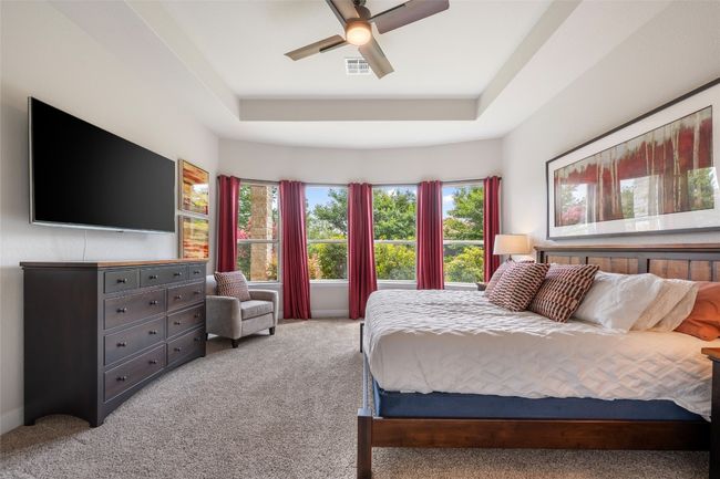 Carpeted bedroom with a tray ceiling and a ceiling fan | Image 17