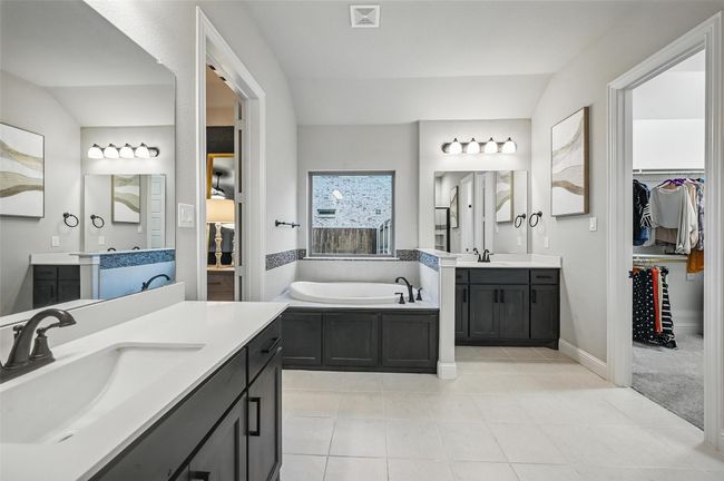 Full bath featuring tile patterned flooring, two vanities, a bath, and a walk in closet | Image 26