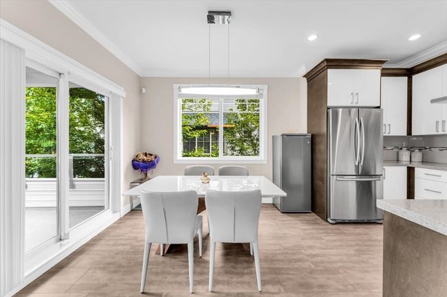 Dining space with plenty of natural light, crown molding, and recessed lighting | Image 12