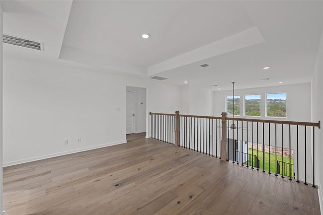 Unfurnished room featuring wood-type flooring, recessed lighting, a tray ceiling, and baseboards | Image 20