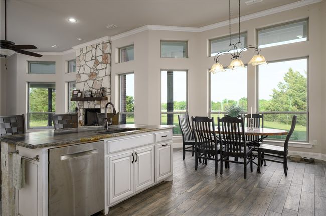 View from Kitchen toward dining. Beautiful sunrises can be seen out of these windows facing east. | Image 15