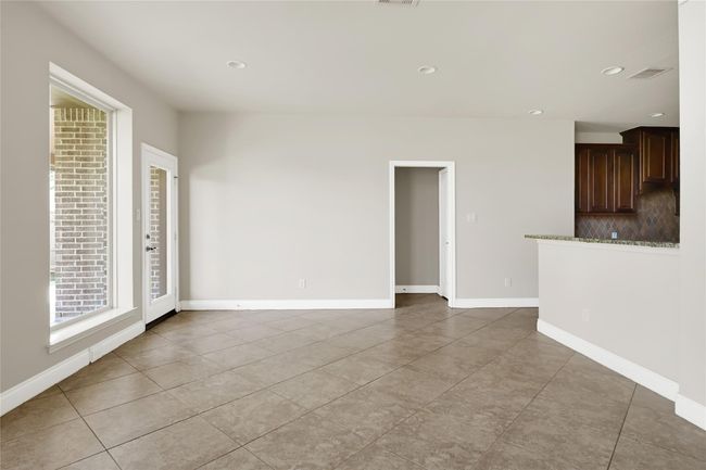 The breakfast area offers morning light and tranquil backyard views, with a nearby glass-paneled door for effortless access to the patio. | Image 15