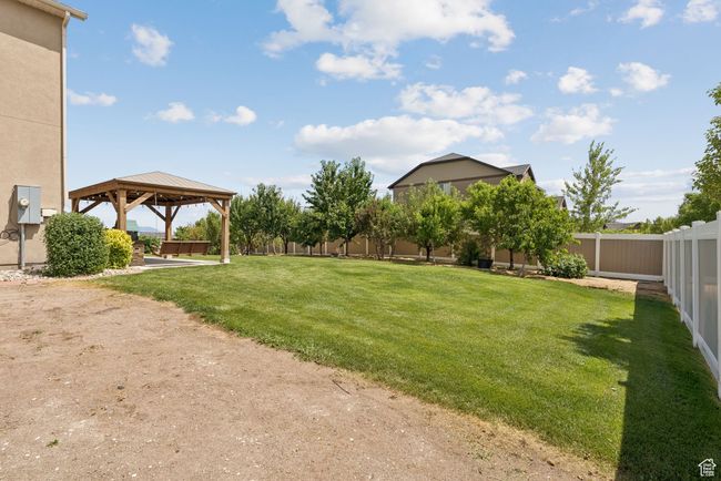 Fenced backyard featuring a gazebo | Image 40