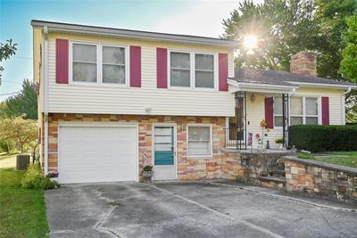 Tri-level home featuring cooling unit and a garage | Image 1