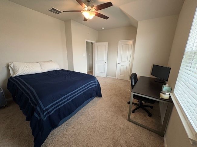 Bedroom featuring carpet flooring, a desk, ceiling fan, and baseboards | Image 11