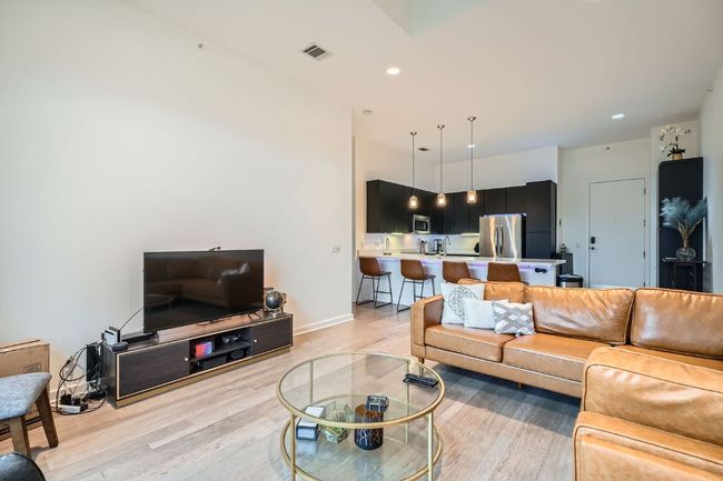 Living room with recessed lighting, baseboards, light wood-style floors, and visible vents | Image 7