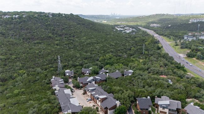 Aerial overview of property's location featuring a forest and nearby suburban area | Image 35
