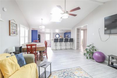 Living room featuring lofted ceiling, ceiling fan, and light wood-type flooring | Image 3