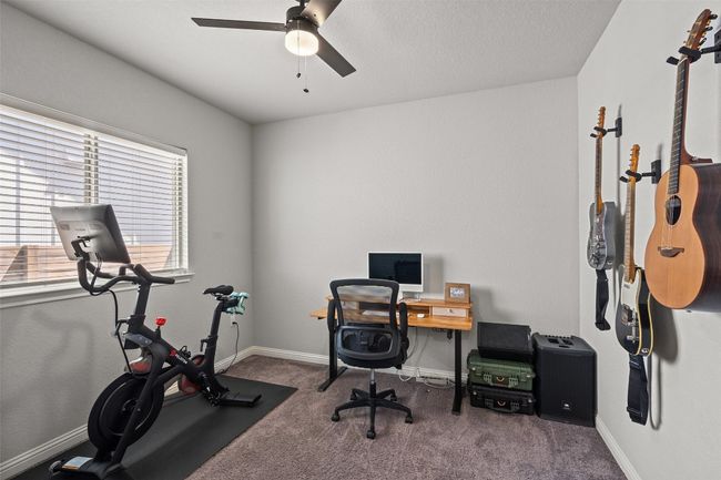 Carpeted office with a ceiling fan and baseboards | Image 23