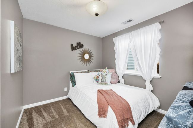 Carpeted bedroom with visible vents and baseboards | Image 28
