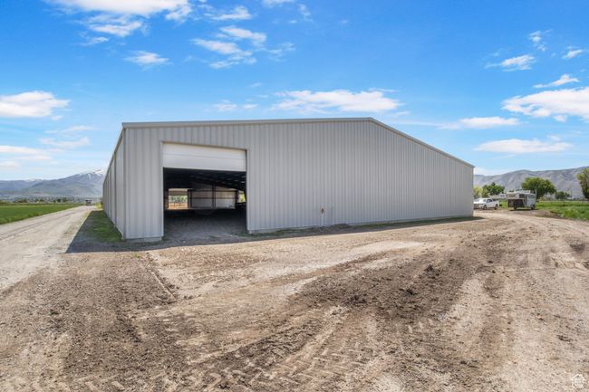 View of pole building featuring a mountain view and driveway | Image 27