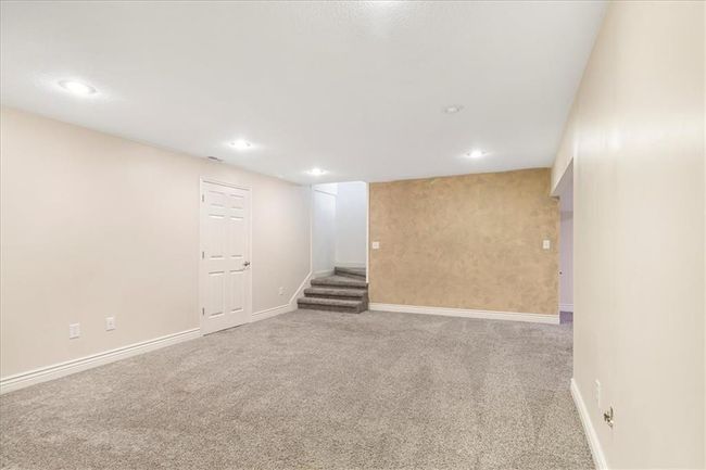 Finished below grade area featuring baseboards, carpet flooring, recessed lighting, and stairs | Image 37
