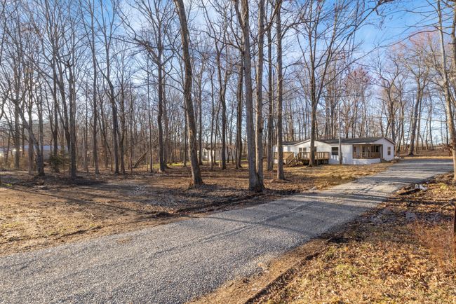 The new gravel driveway adds to the home's charm, providing a fresh, clean look and a smooth entry to your peaceful retreat. | Image 16