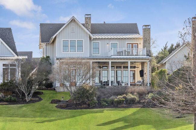Rear view of house featuring a balcony, a chimney, and board and batten siding | Image 30