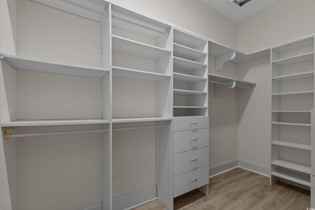 Spacious closet with wood finished floors | Image 23