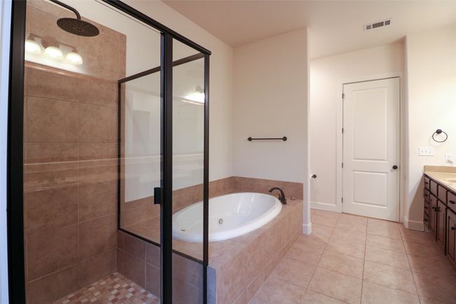 Full bathroom with a stall shower, a garden tub, visible vents, and tile patterned floors | Image 21