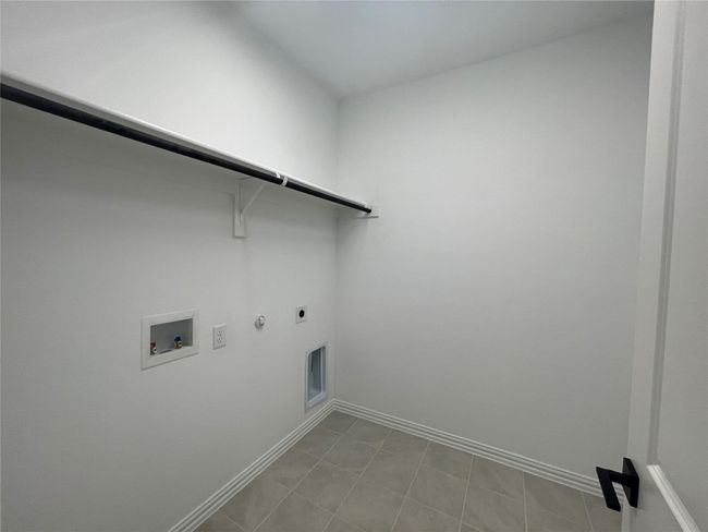 Washroom featuring hookup for a gas dryer, electric dryer hookup, and hookup for a washing machine | Image 33