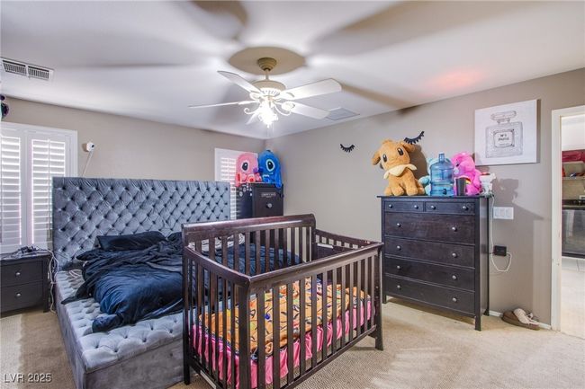 Bedroom featuring carpet, a ceiling fan, and multiple windows | Image 16