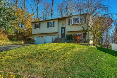 Split foyer home with a garage and a front yard | Image 2