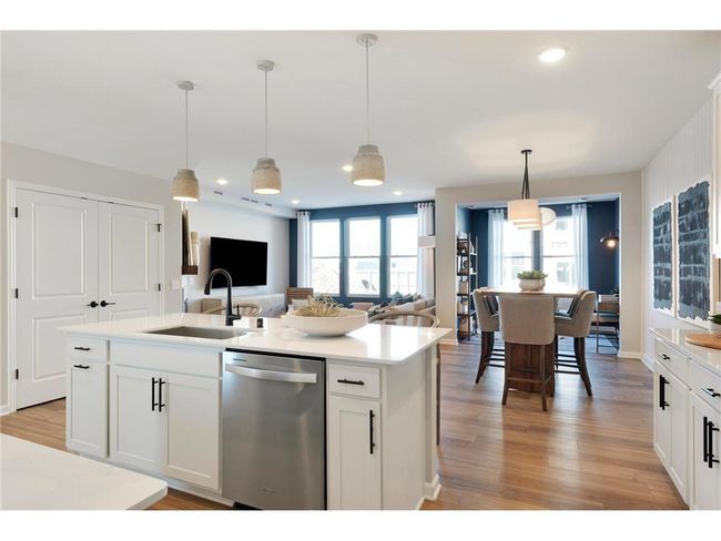 The Ashton also features modern white cabinets that complement the stainless-steel appliances perfectly! Photo of model home. | Image 26