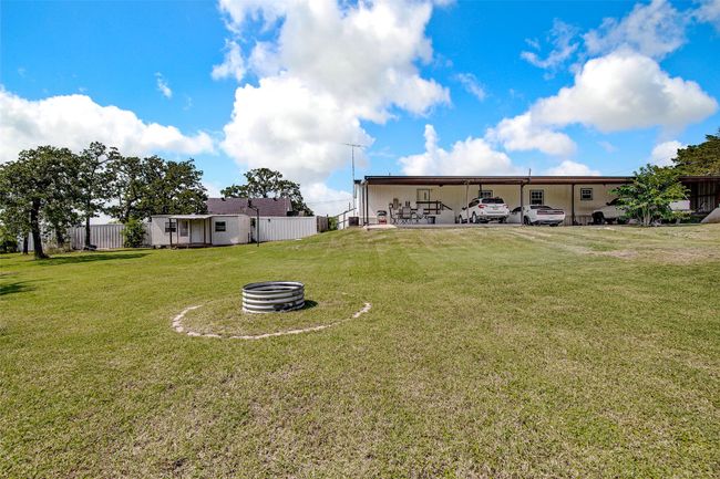 View of the back of the main house with an extended covered carport | Image 35