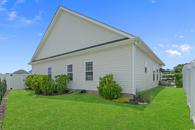 View of home's exterior with a gate and a fenced backyard | Image 36