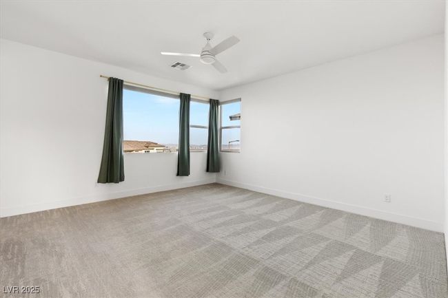 Unfurnished room featuring light colored carpet, visible vents, a ceiling fan, and baseboards | Image 32