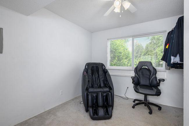 Home office featuring carpet floors, ceiling fan, and a textured ceiling | Image 31