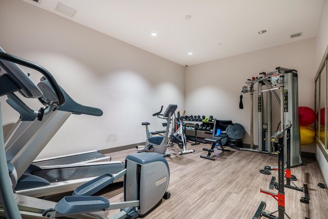 Workout room featuring wood finished floors and recessed lighting | Image 24