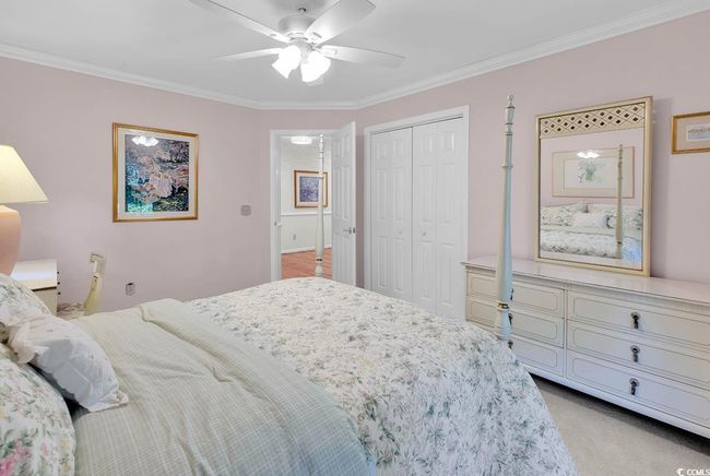 Bedroom featuring ornamental molding, a closet, ceiling fan, and light colored carpet | Image 17
