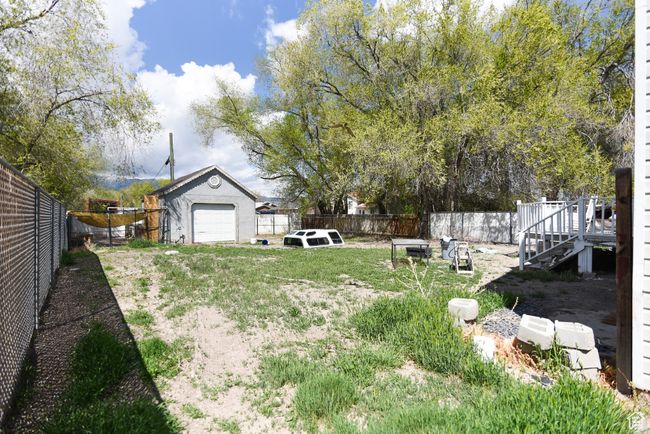 View of yard with a fenced backyard, a wooden deck, and stairs | Image 32