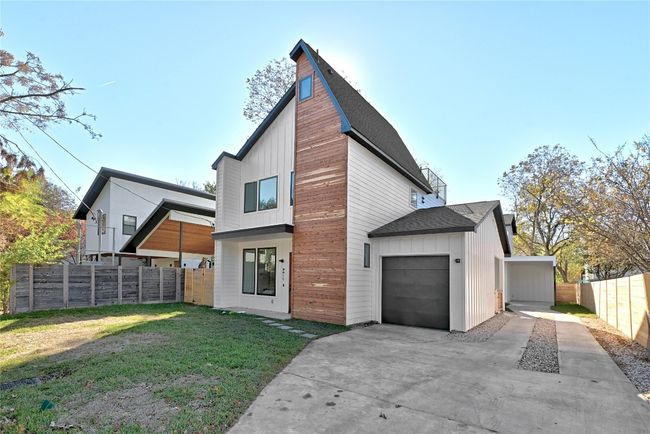 Rear view of house featuring a garage and a yard | Image 23